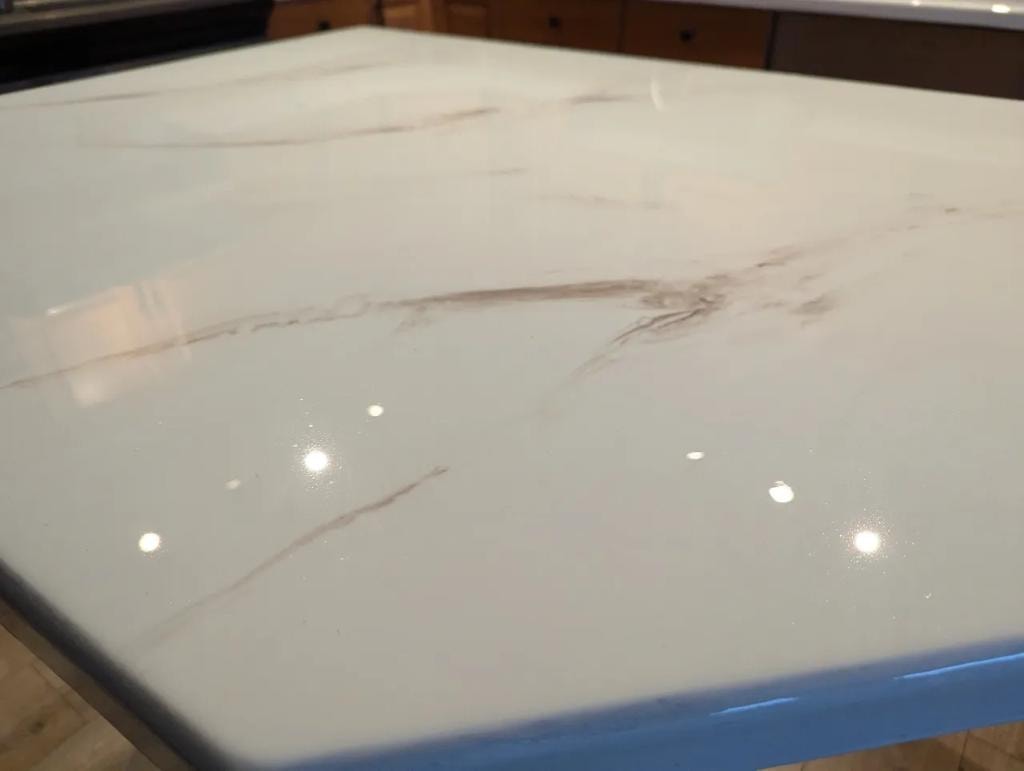 Close-up white marble epoxy countertop finish Calgary — subtle veining