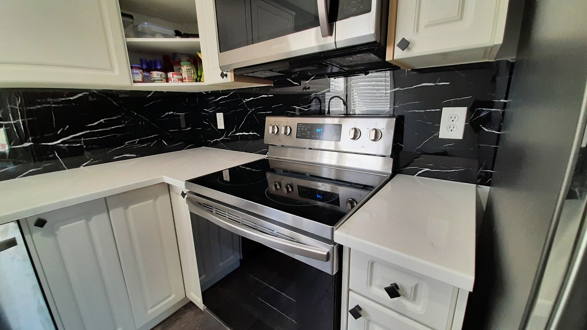 Black marble-look backsplash refacing Calgary kitchen