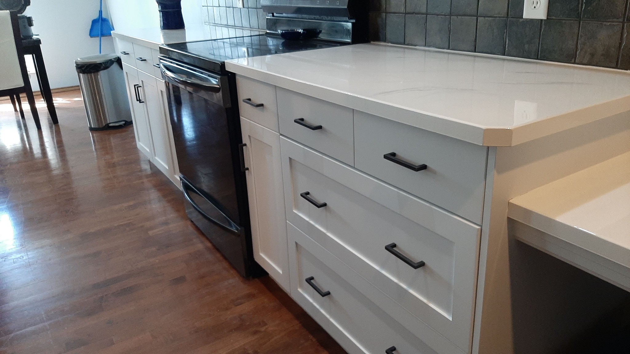 Light grey cabinet painting with white countertop Calgary kitchen