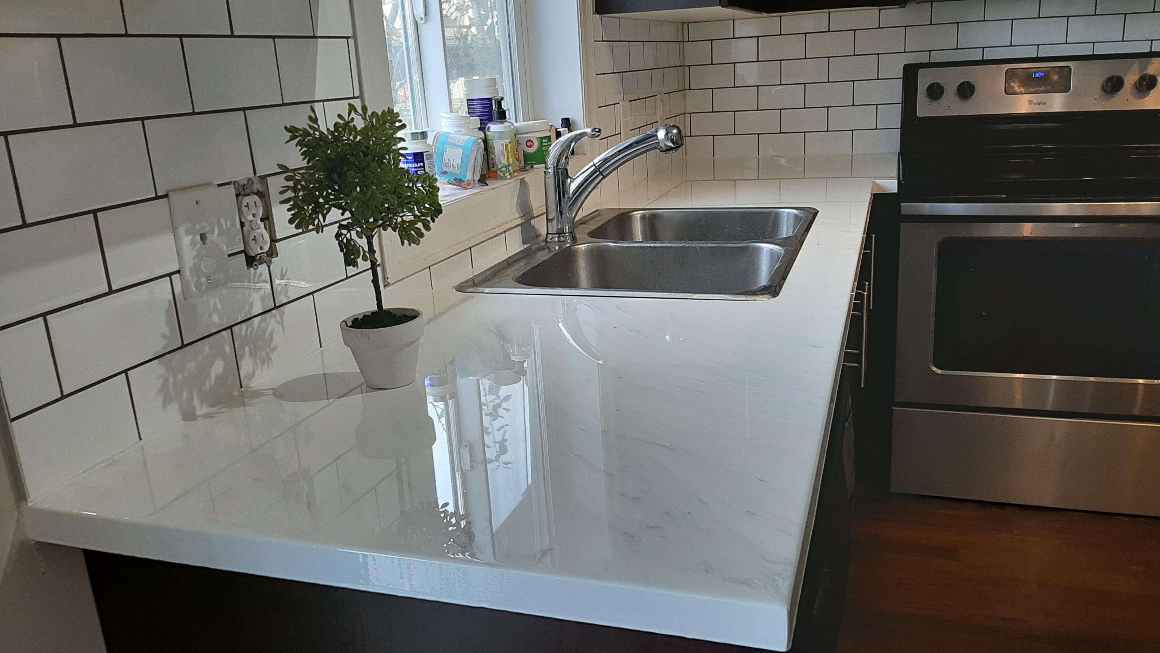 White epoxy countertop with subway tile kitchen backsplash Calgary